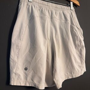 Two pairs of Men’s Lululemon; Light Khaki and Black Athletic Shorts